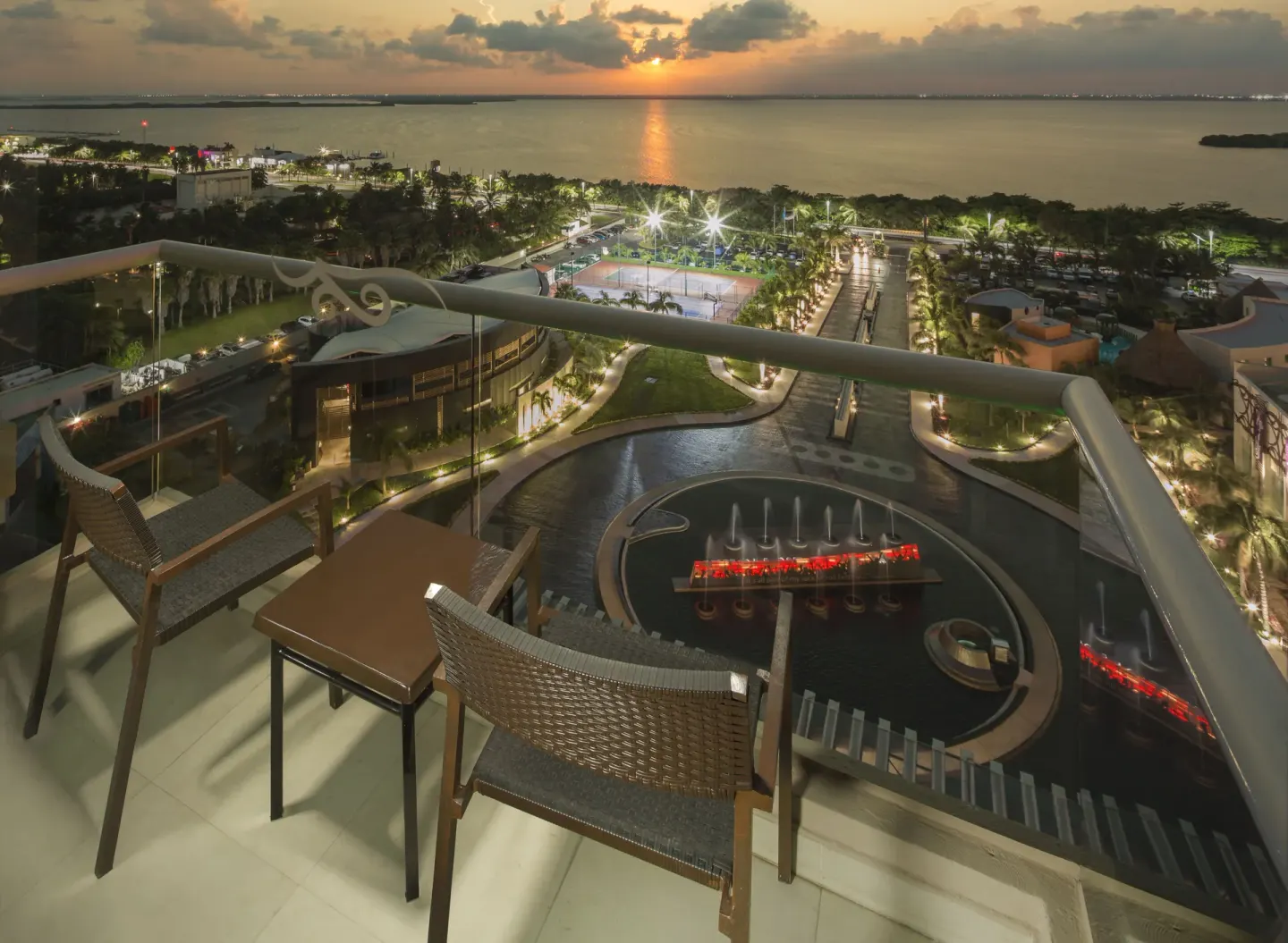 Balcony seating overlooking the resort grounds at sunset at Hard Rock Hotel Cancun.