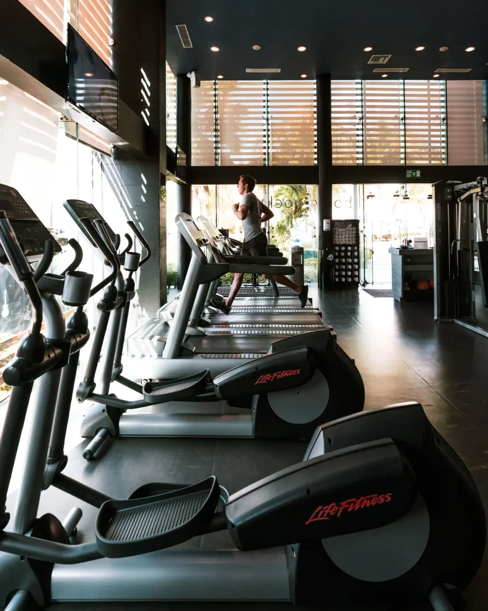 Fitness room with cardio machines and a runner at Hard Rock Hotel Cancun.