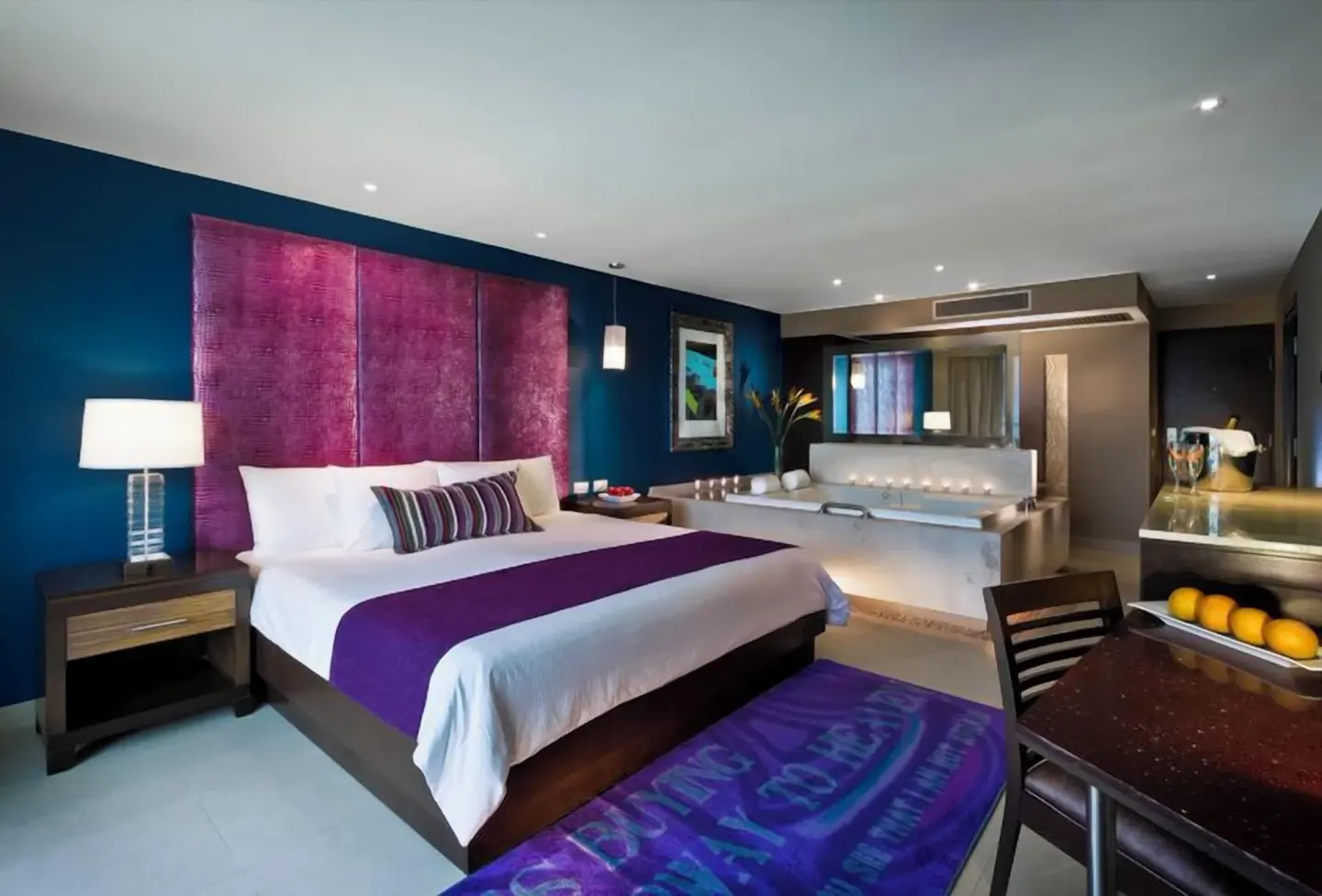 King bed guest room with a whirlpool tub and dining area at Hard Rock Hotel Cancun.