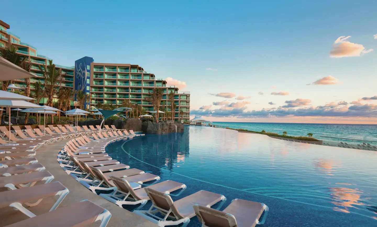 Infinity pool with ocean views and lounge chairs at Hard Rock Hotel Cancun.