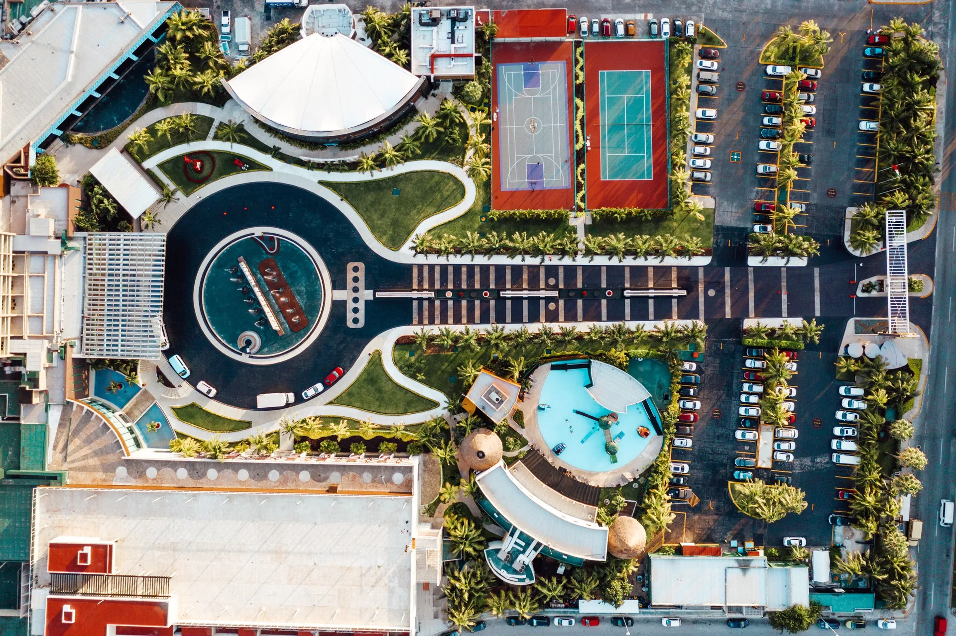 Overhead view of pools, courts, paths, and parking at Hard Rock Hotel Cancun.