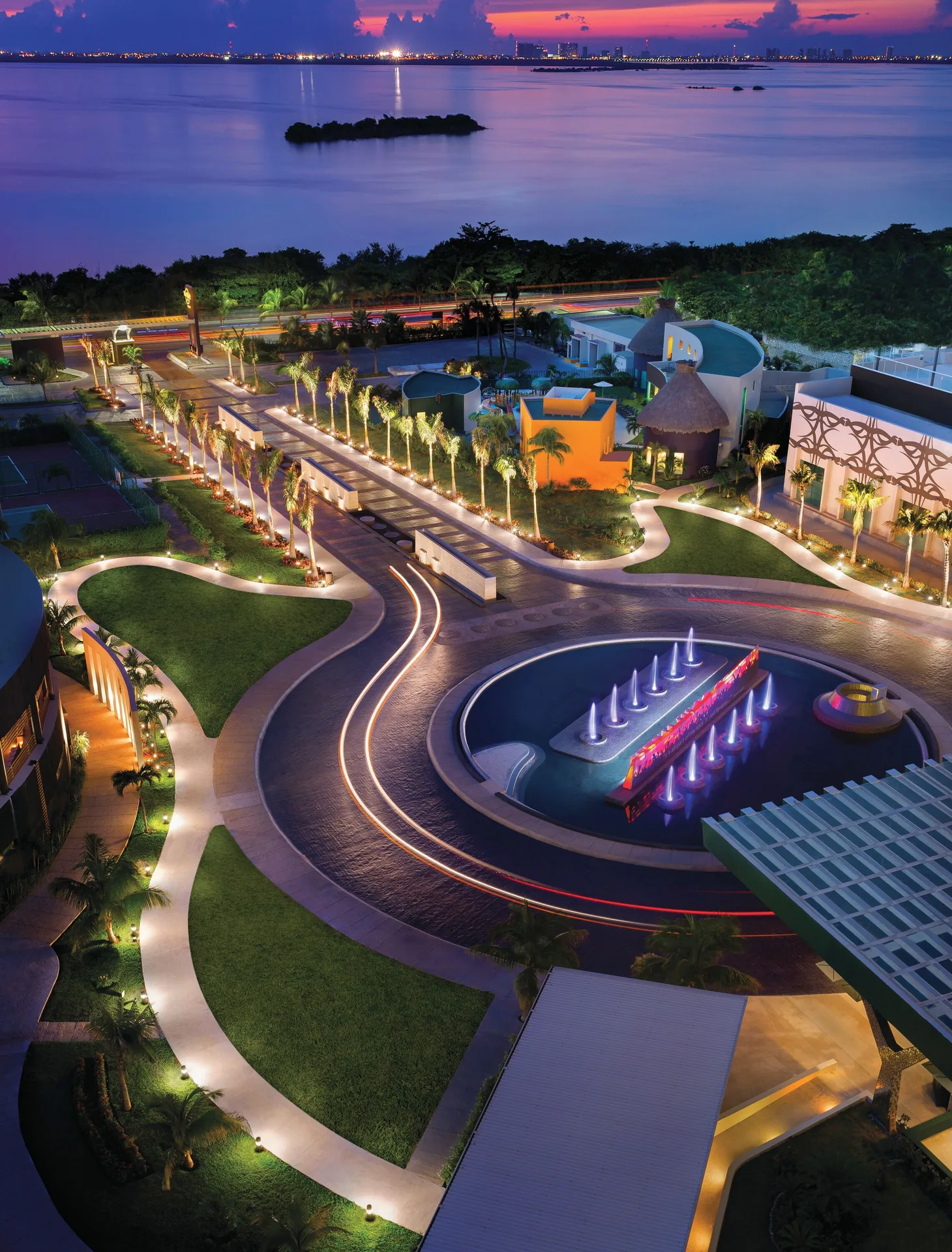 Illuminated resort grounds and lagoon at sunset at Hard Rock Hotel Cancun.