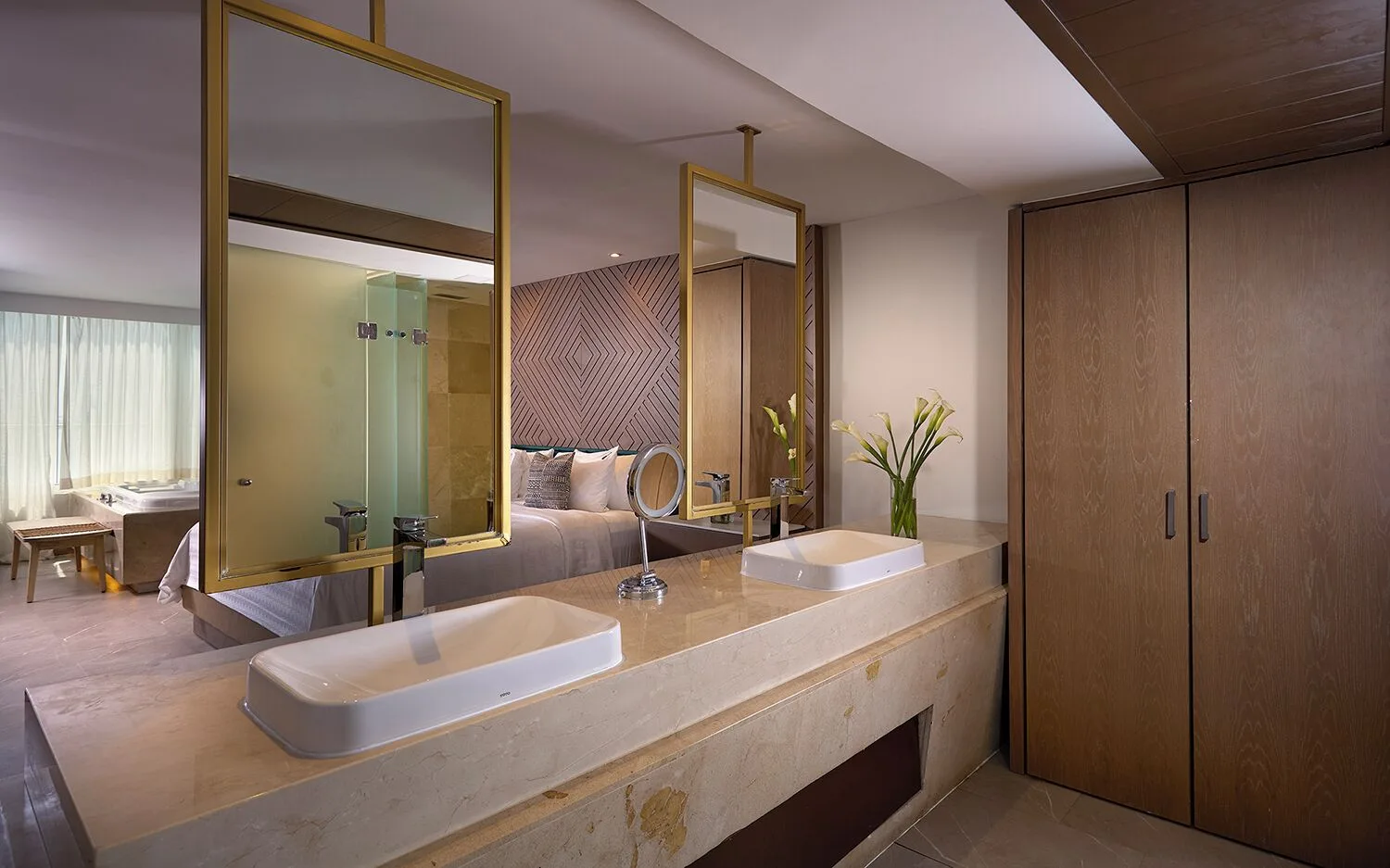 Double vanity and bedroom view in a suite at Hard Rock Hotel Cancun.
