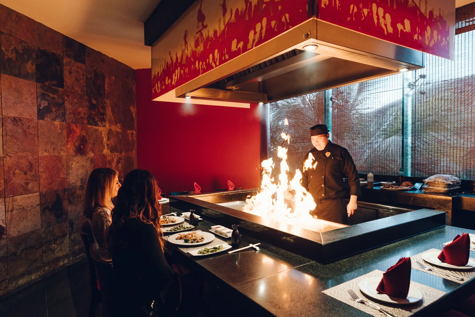 Chef cooks with flames on a teppanyaki grill at Hard Rock Hotel Cancun.