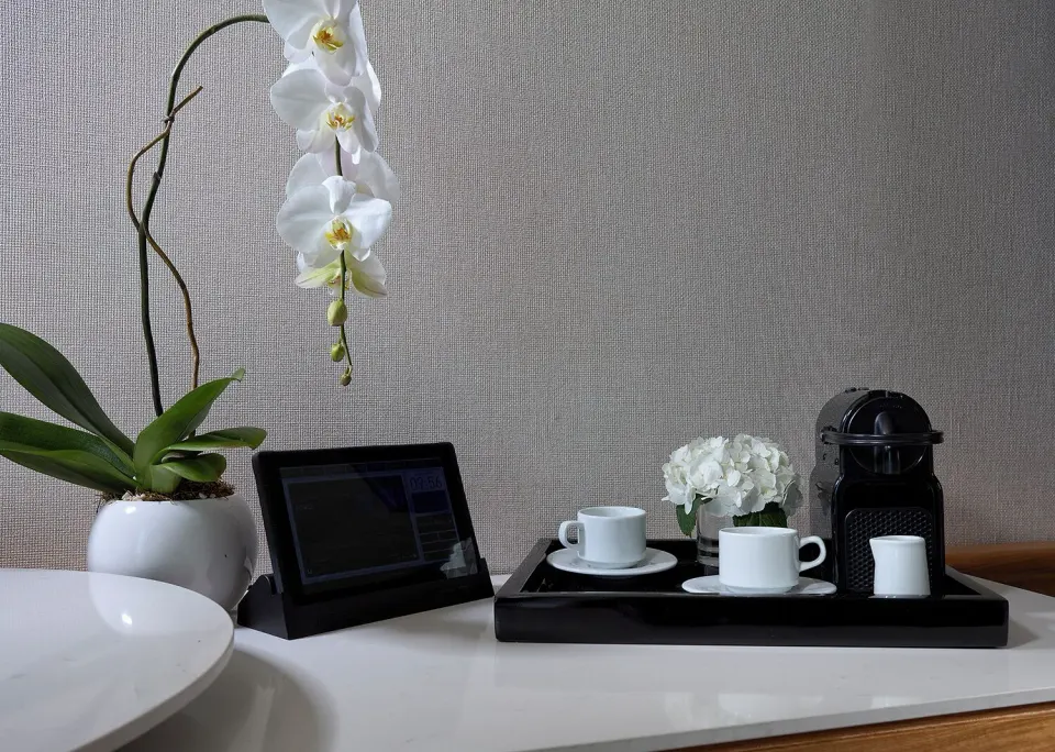 Deluxe Lagoon View room coffee setup and orchid at Hard Rock Hotel Cancun.
