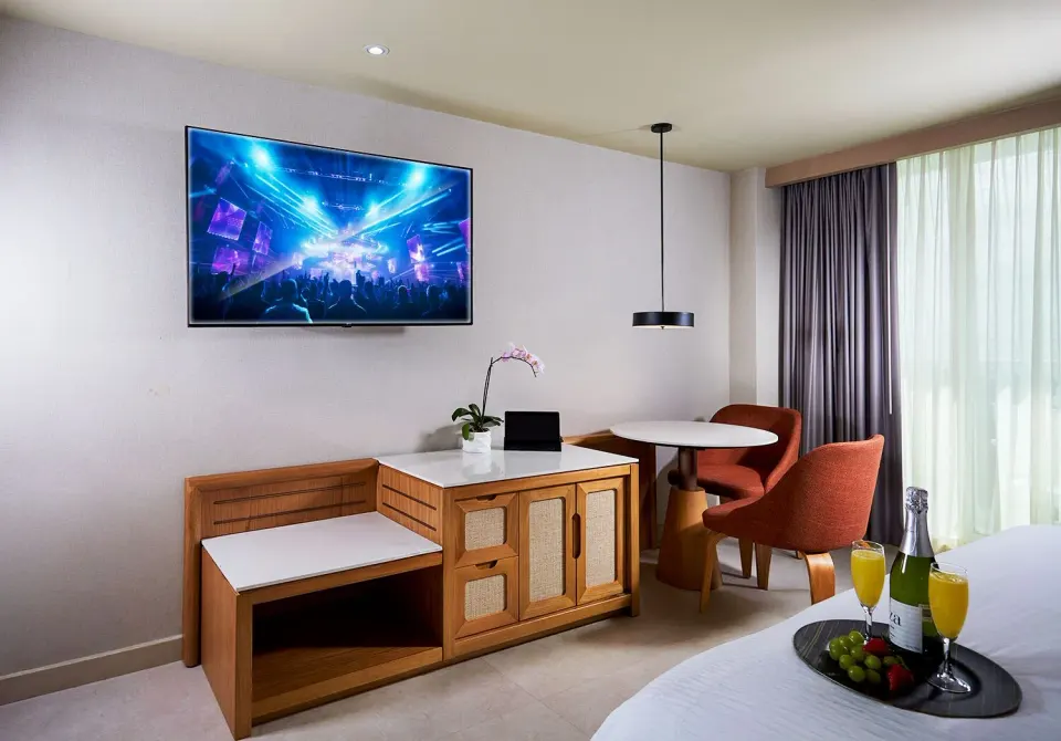 Deluxe Lagoon View room sitting area and bed at Hard Rock Hotel Cancun.