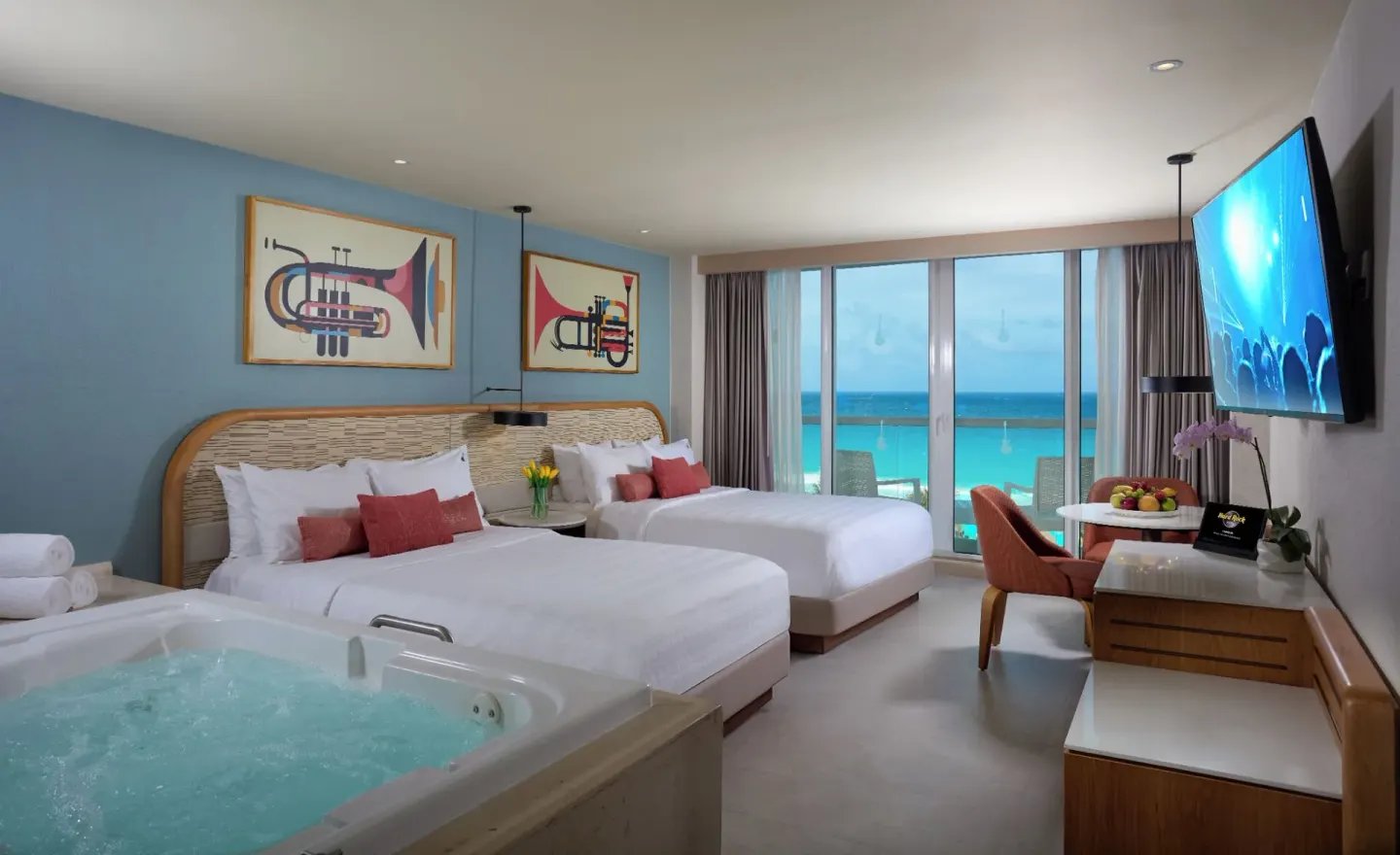 Deluxe Ocean View room with two beds, in-room tub, balcony, and sea view at Hard Rock Hotel Cancun.