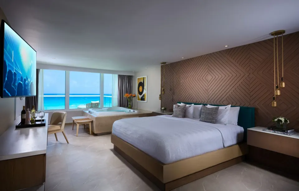 Rock Royalty Level Rock Star Suite bedroom with king bed and ocean view at Hard Rock Hotel Cancun.