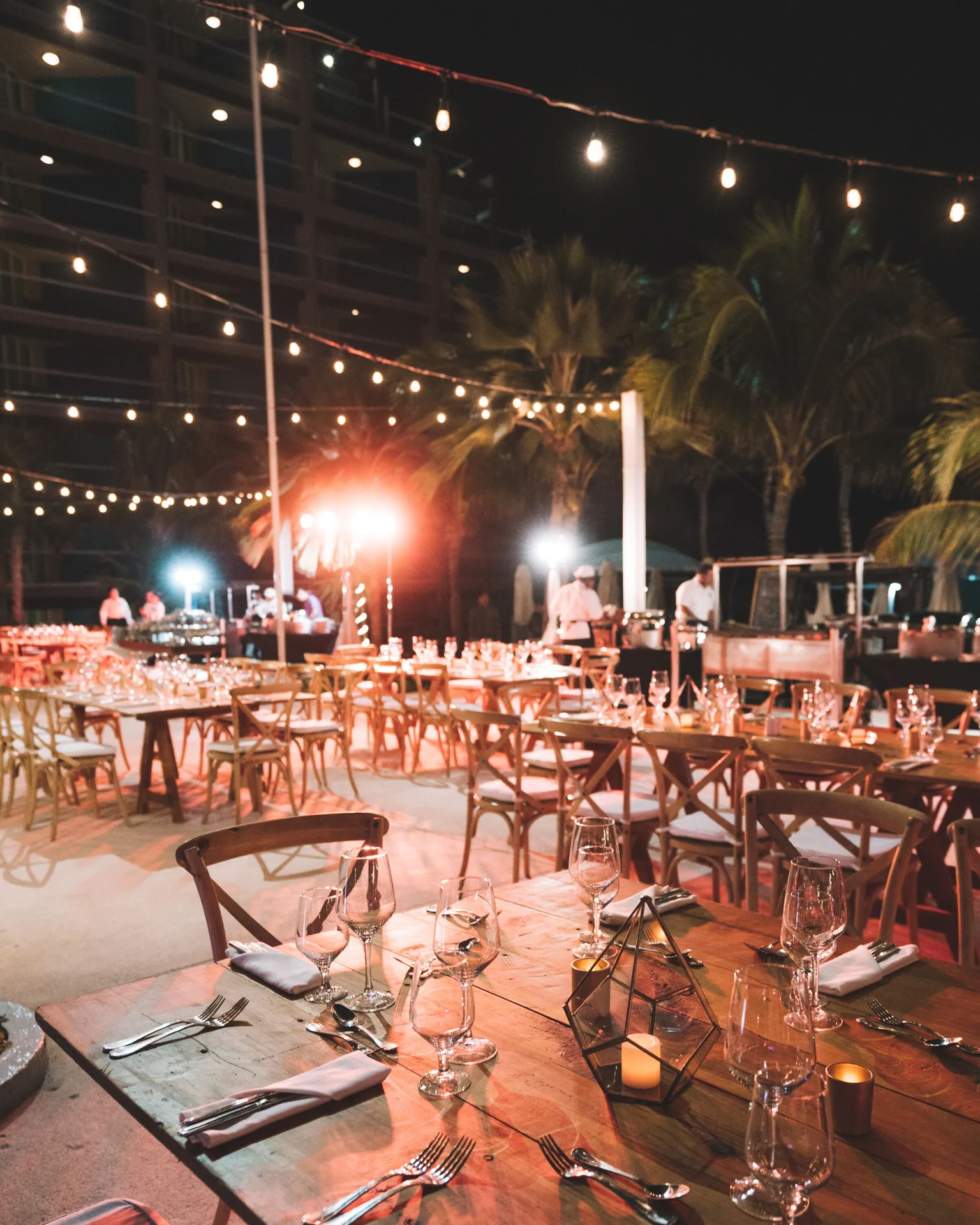 Outdoor evening event tables under string lights at Hard Rock Hotel Cancun.