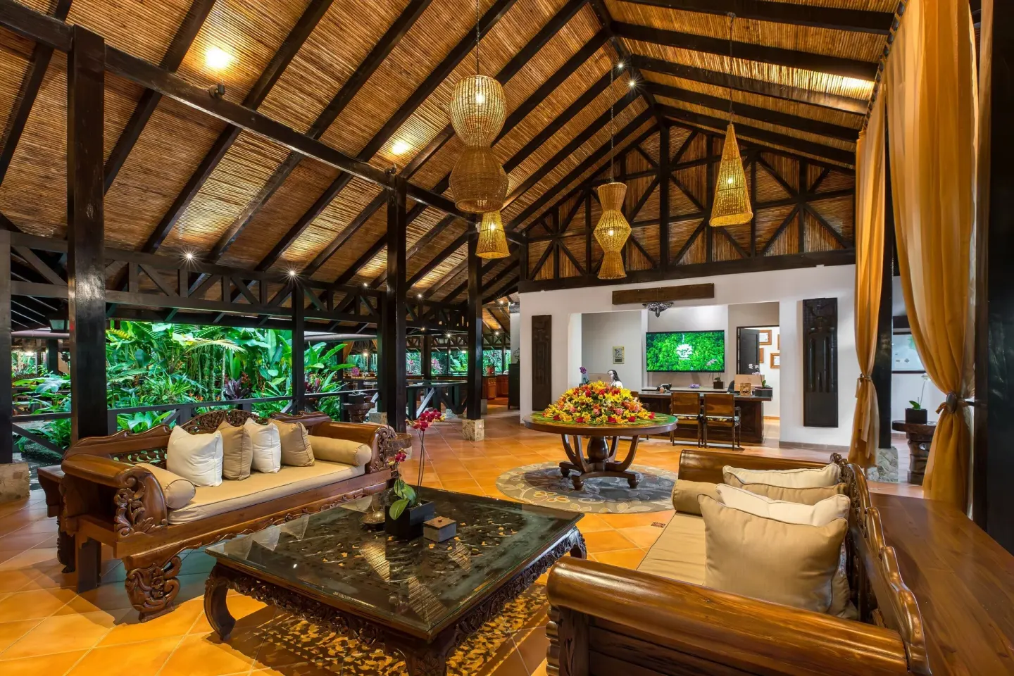 Open-air lobby lounge with carved wood seating at Hideaway Rio Celeste.