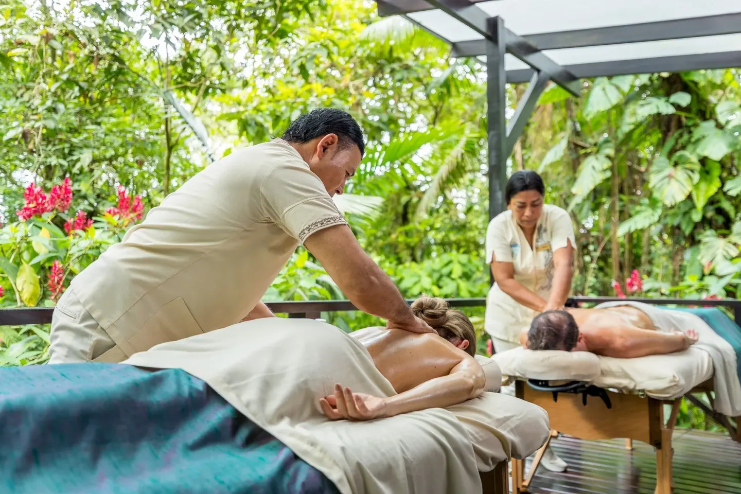 Couple receiving outdoor massages amid tropical gardens at Hideaway Rio Celeste.