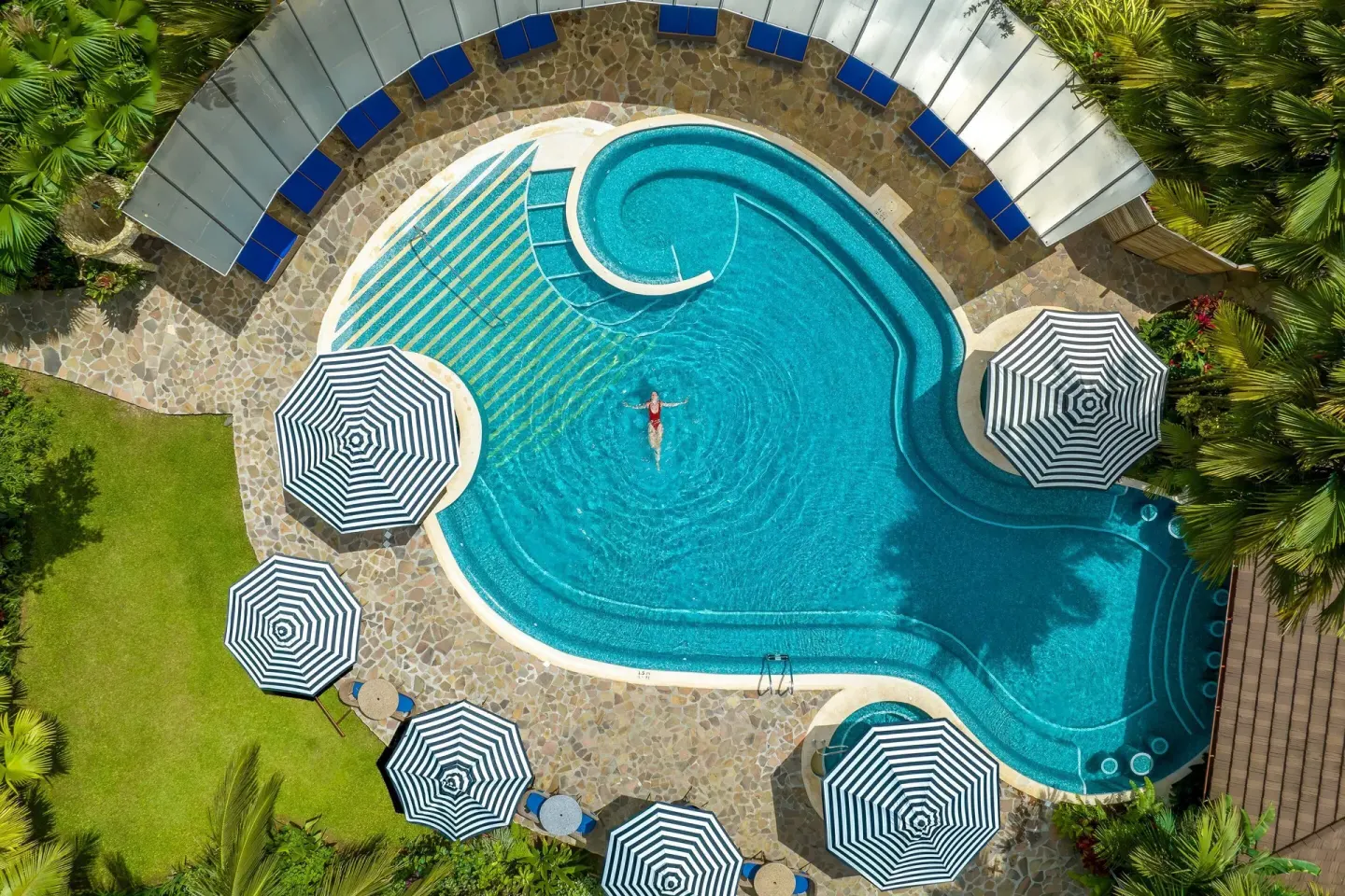 Top-down view of the pool with a swimmer at Hideaway Rio Celeste.