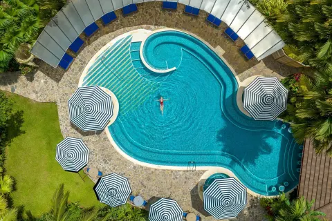 Top-down view of the pool with a swimmer at Hideaway Rio Celeste.