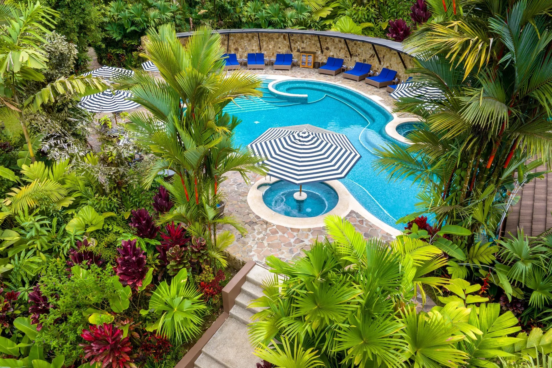 Pool surrounded by dense tropical gardens at Hideaway Rio Celeste.