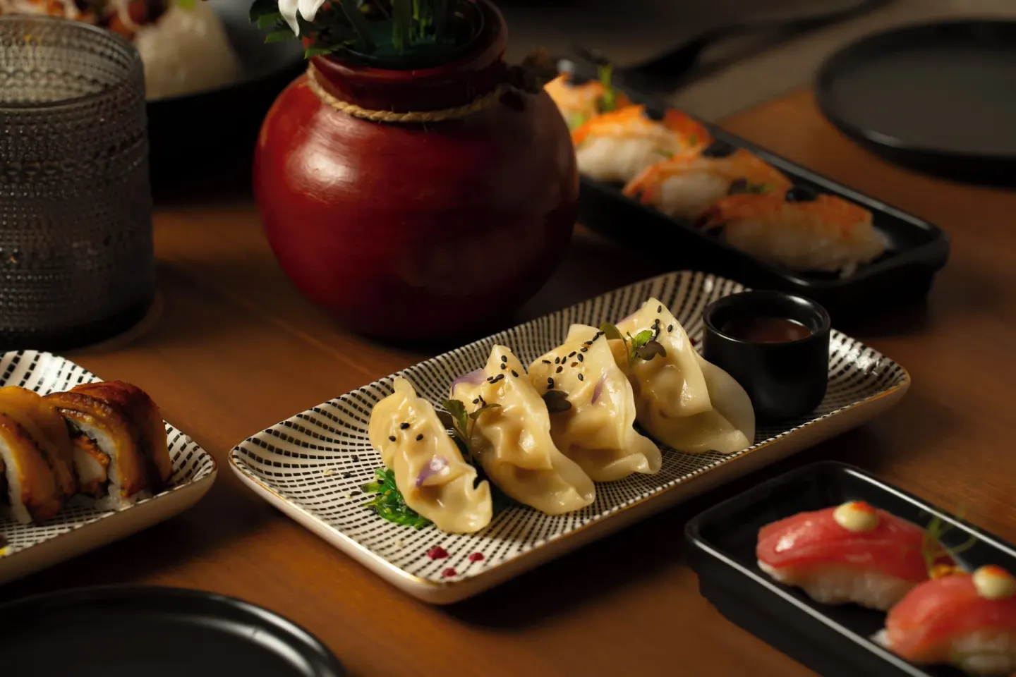 Dumplings, sushi, and small plates arranged on a table at Hideaway Rio Celeste.