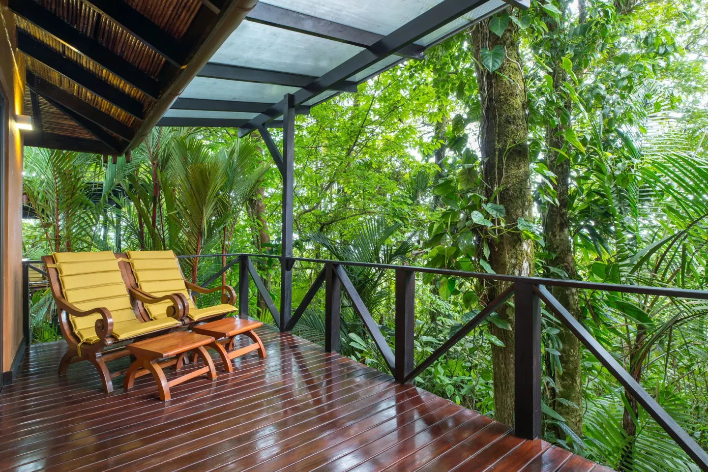 Forest View Casita terrace with lounge chairs in the rainforest at Hideaway Rio Celeste.