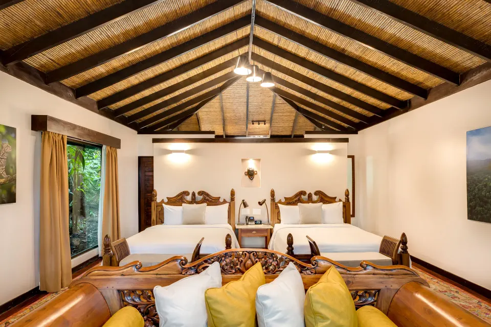 Garden View Casita with two beds and a large window at Hideaway Rio Celeste.