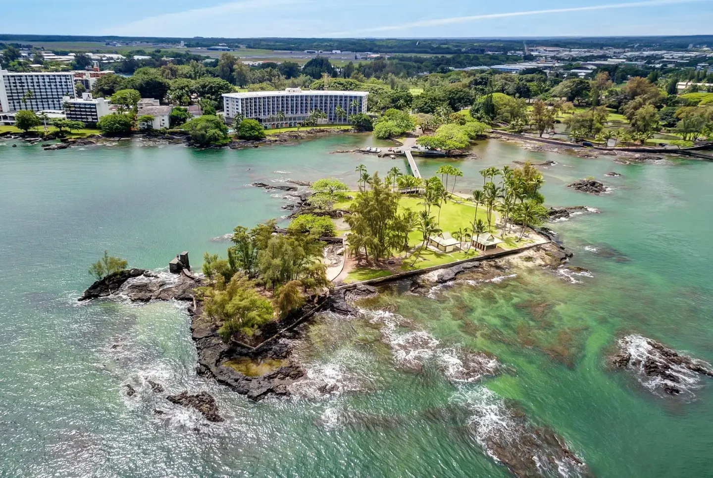 Aerial view of Coconut Island and the hotel shoreline at Hilo Hawaiian Hotel.