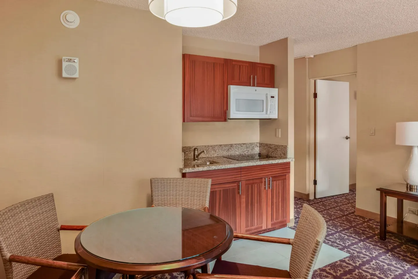 Guest room kitchenette and round dining table at Hilo Hawaiian Hotel.
