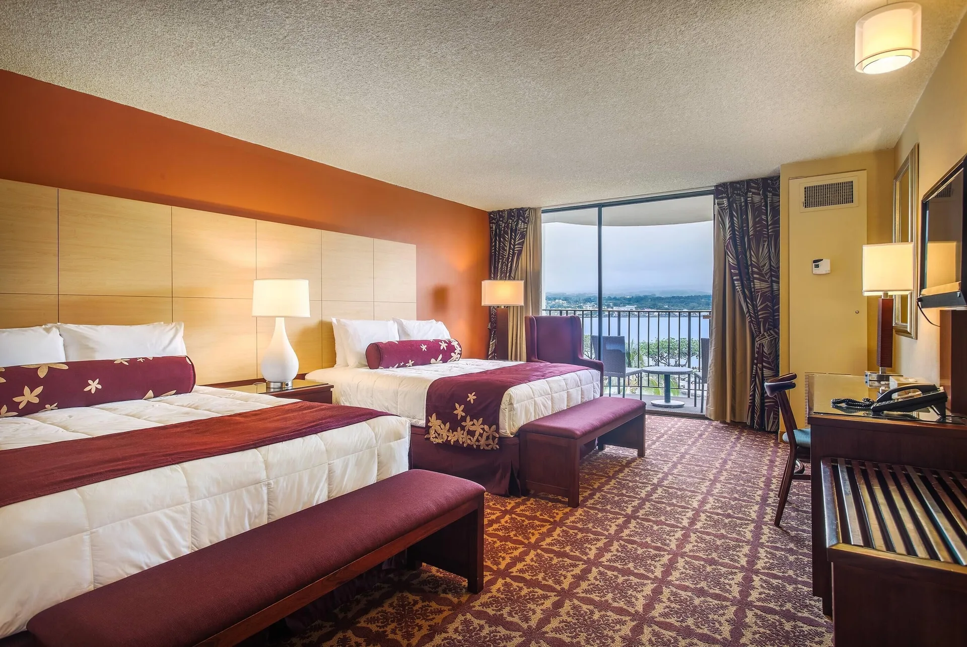 Premium oceanfront room with two beds and balcony at Hilo Hawaiian Hotel.
