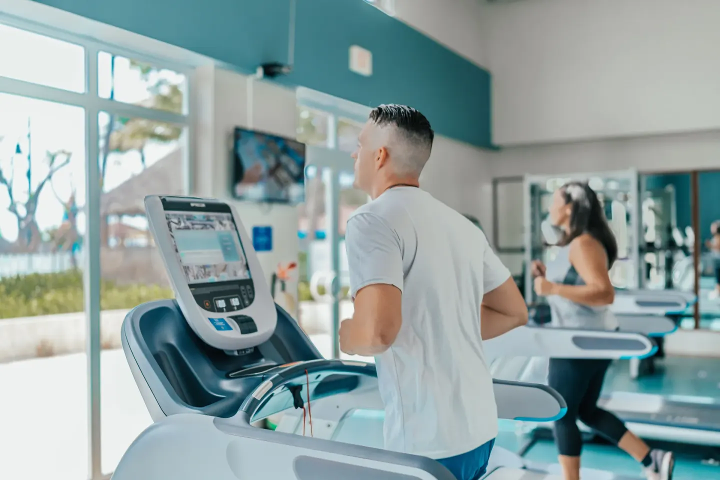 Guests using treadmills in the fitness center at Hilton Aruba Caribbean Resort and Casino.