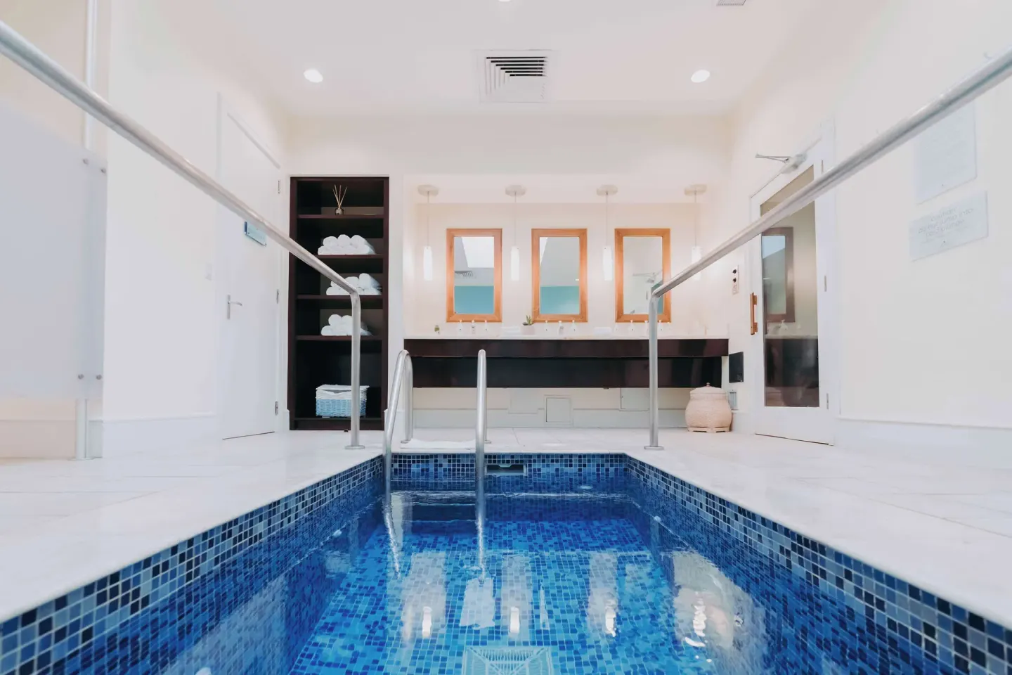 Indoor spa pool with blue tile and vanity area at Hilton Aruba Caribbean Resort and Casino.
