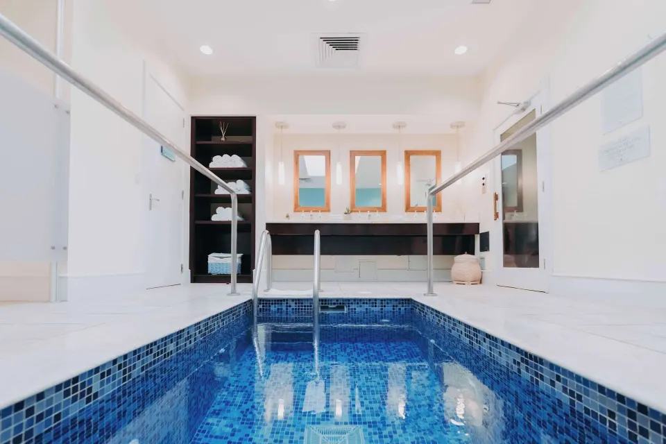 Indoor spa pool with blue tile and vanity area at Hilton Aruba Caribbean Resort and Casino.