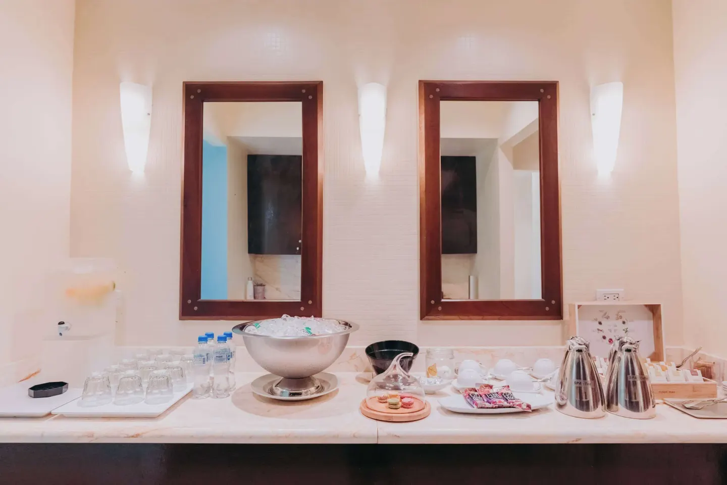 Spa vanity with mirrors, glassware, towels, and refreshments at Hilton Aruba Caribbean Resort and Casino.