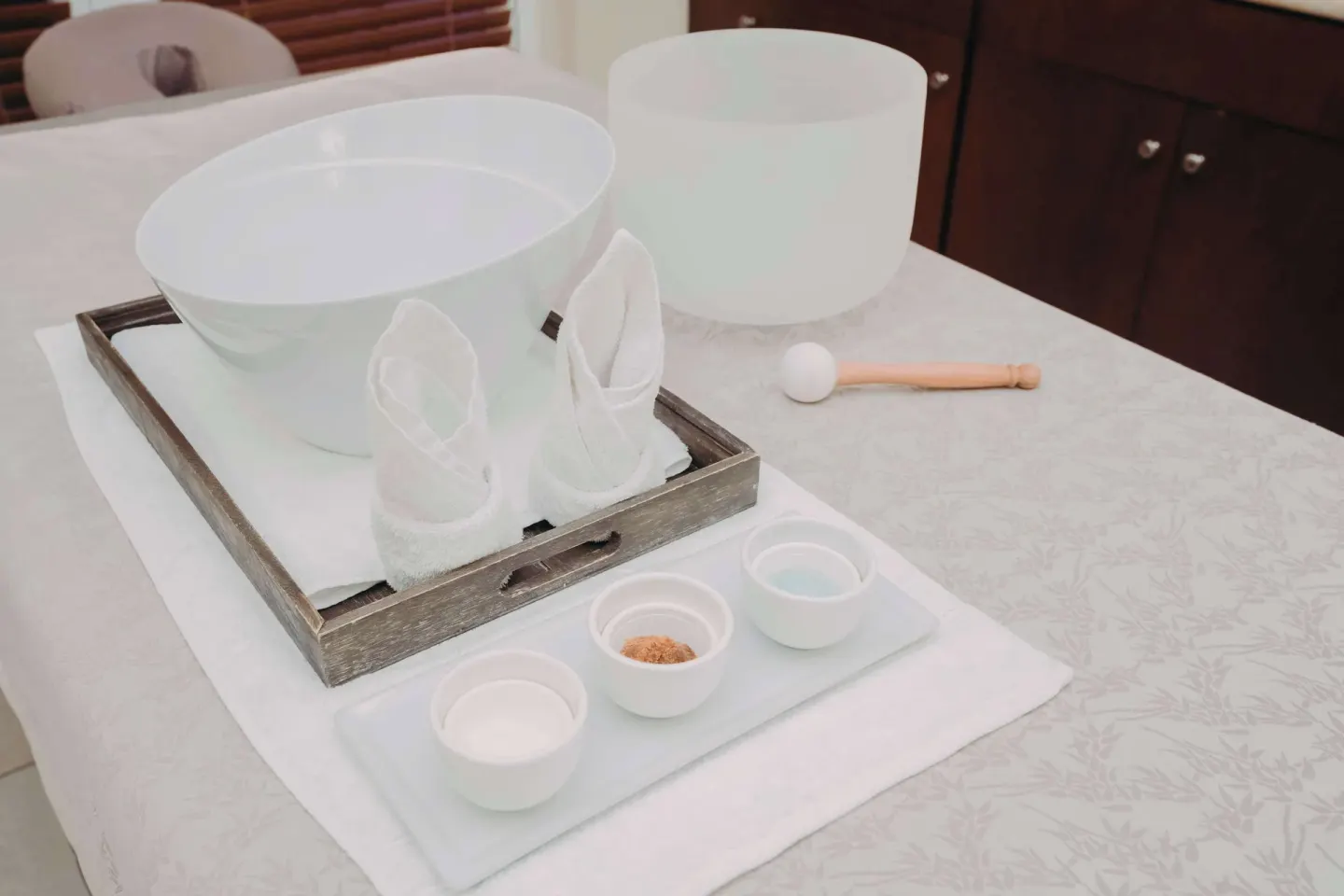 Spa treatment setup with bowls, towels, and sound bowls at Hilton Aruba Caribbean Resort and Casino.