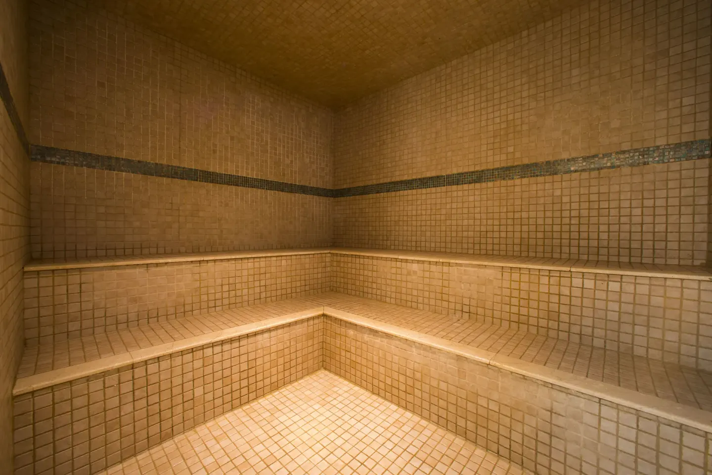 Tiled steam room with tiered benches at Hilton Aruba Caribbean Resort and Casino.