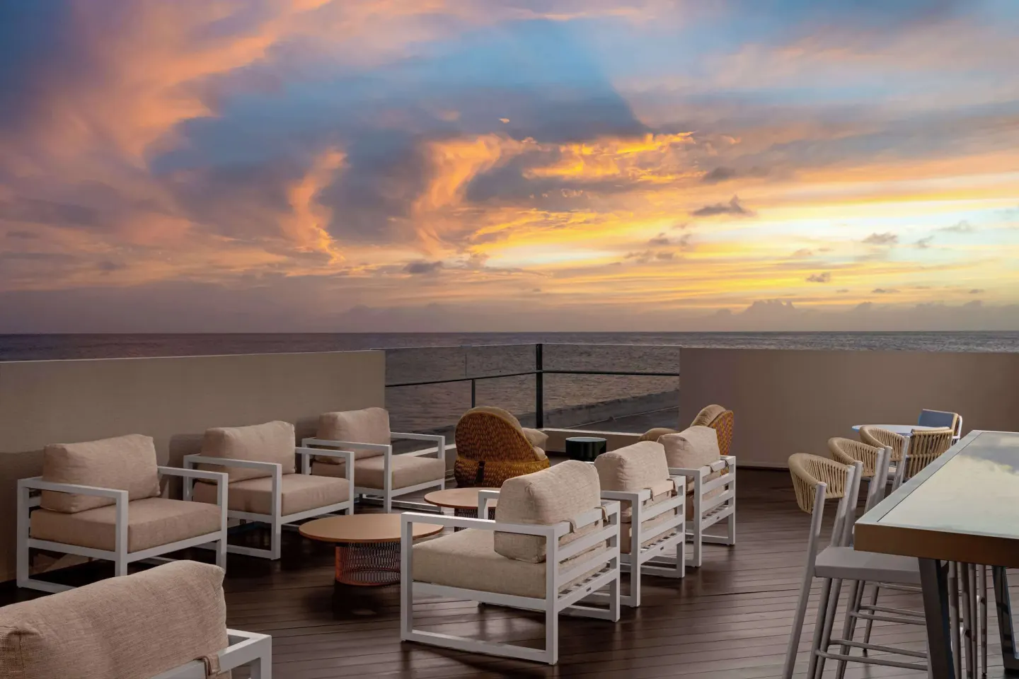 Outdoor oceanview lounge seating at sunset at Hilton Aruba Caribbean Resort and Casino.
