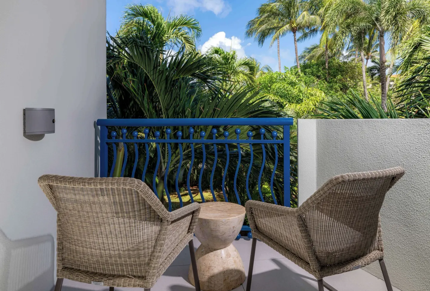 Garden-view balcony seating at Hilton Aruba Caribbean Resort and Casino.