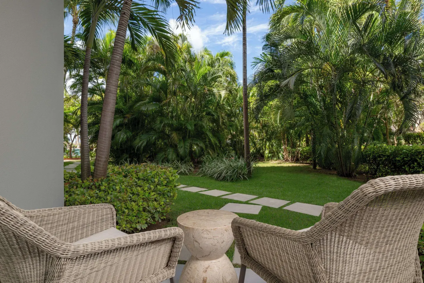 Garden patio with wicker chairs at Hilton Aruba Caribbean Resort and Casino.