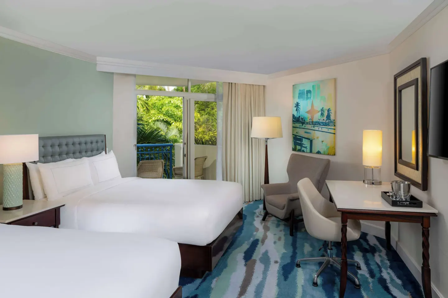 Two-bed garden-view room with balcony at Hilton Aruba Caribbean Resort and Casino.