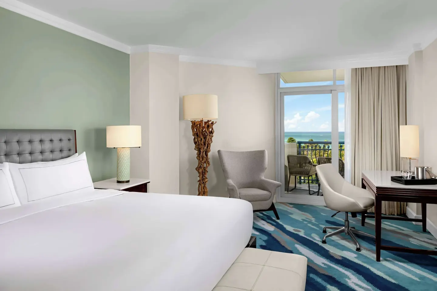 Ocean View room with king bed, desk, and balcony at Hilton Aruba Caribbean Resort and Casino.