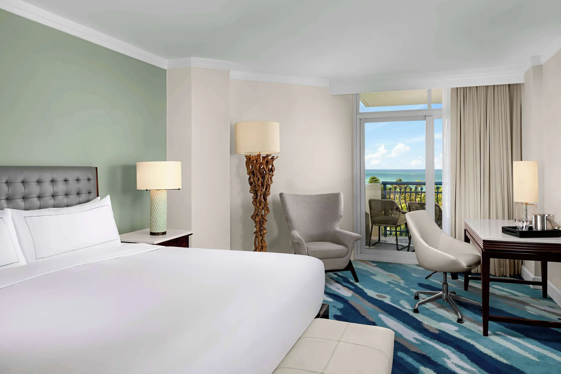 Ocean View room with king bed, desk, and balcony at Hilton Aruba Caribbean Resort and Casino.