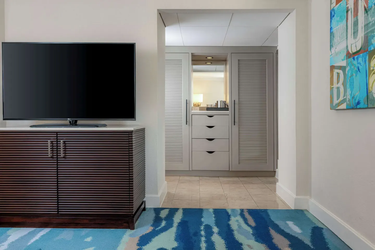 Palm Beach Club room television and closet alcove at Hilton Aruba Caribbean Resort and Casino.