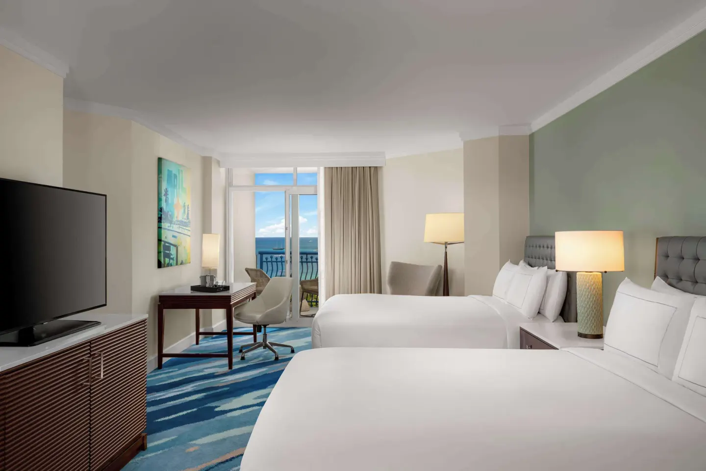 Palm Beach Club room with two beds and ocean-view balcony at Hilton Aruba Caribbean Resort and Casino.