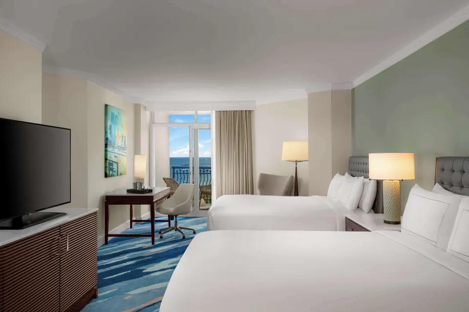 Palm Beach Club room with two beds and ocean-view balcony at Hilton Aruba Caribbean Resort and Casino.