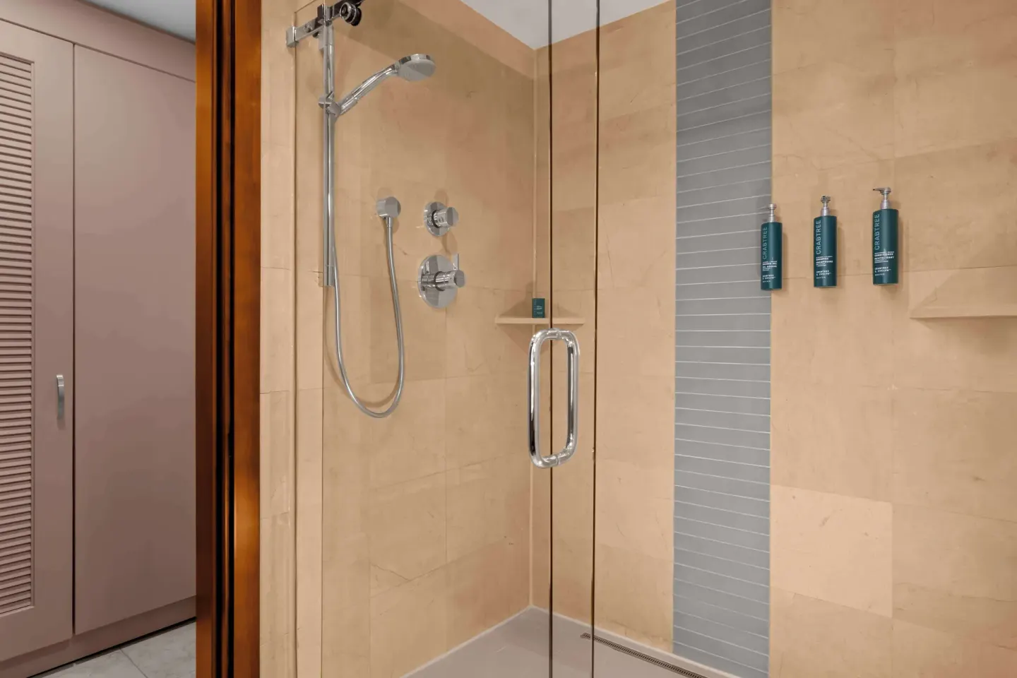 Suite bathroom glass shower with tiled walls at Hilton Aruba Caribbean Resort and Casino.