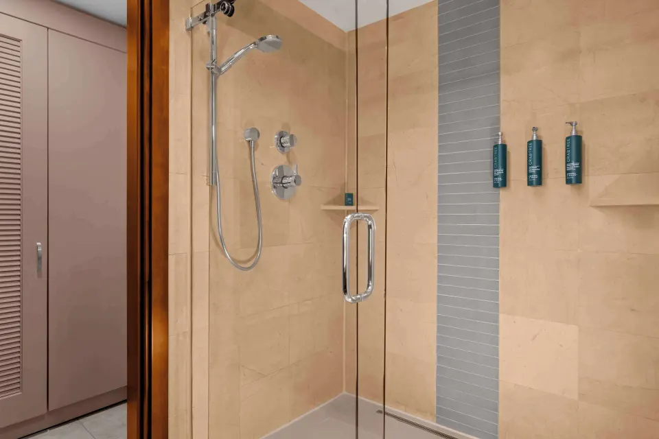Suite bathroom glass shower with tiled walls at Hilton Aruba Caribbean Resort and Casino.