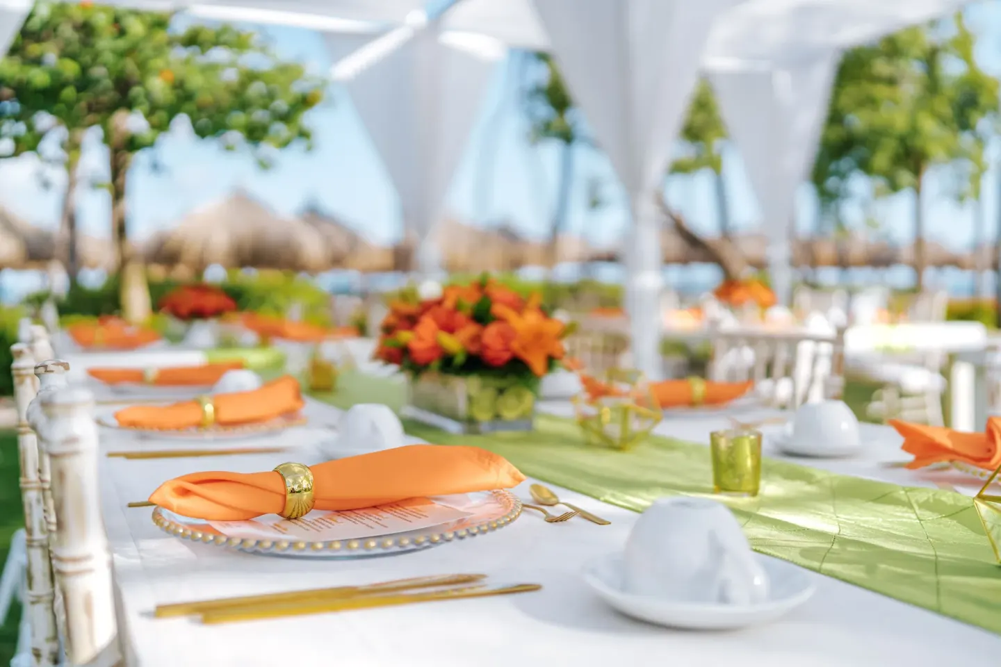 Outdoor event table with orange napkins at Hilton Aruba Caribbean Resort and Casino.