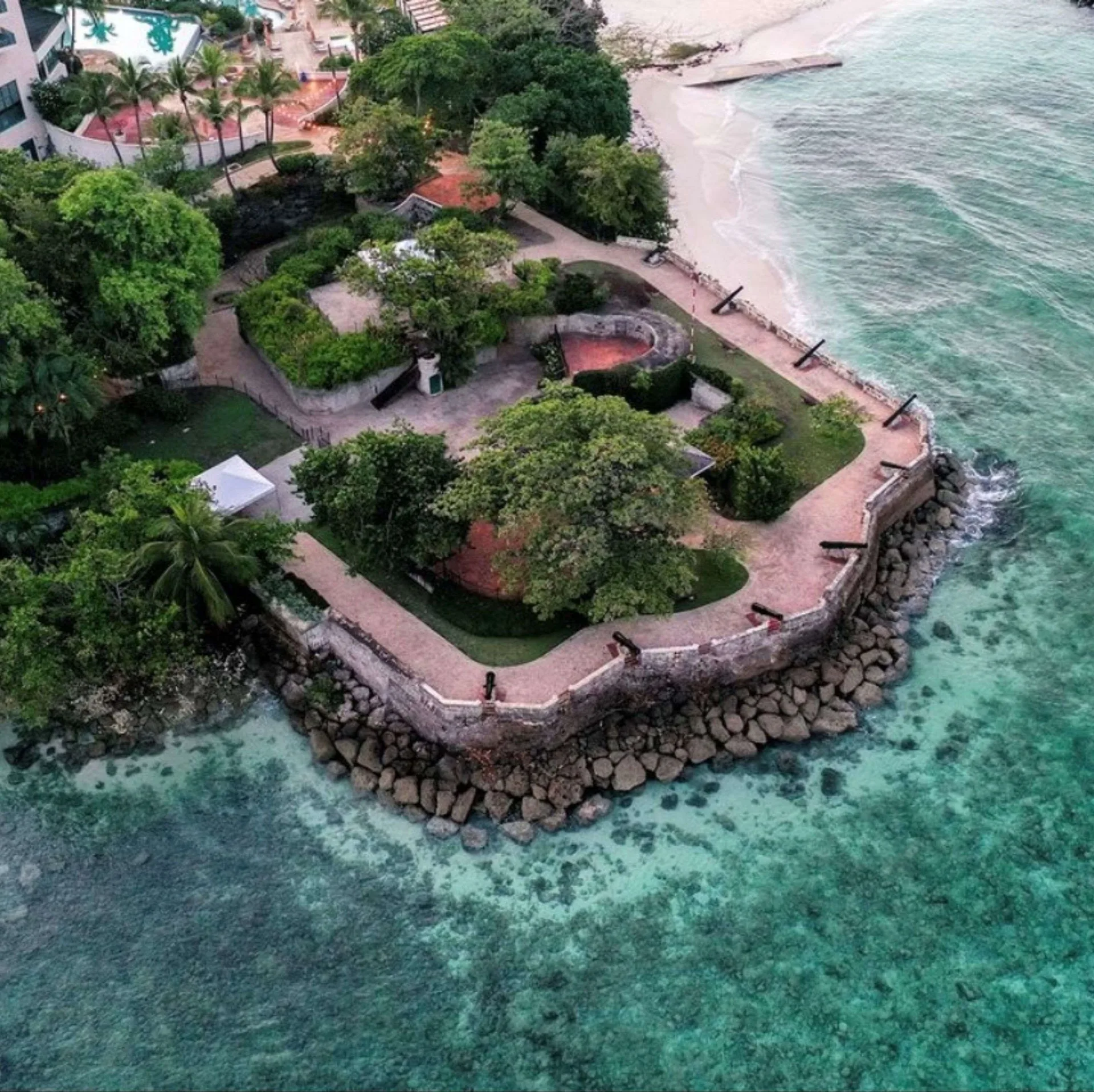 Aerial view of the coastal fort grounds and clear water at Hilton Barbados Resort.