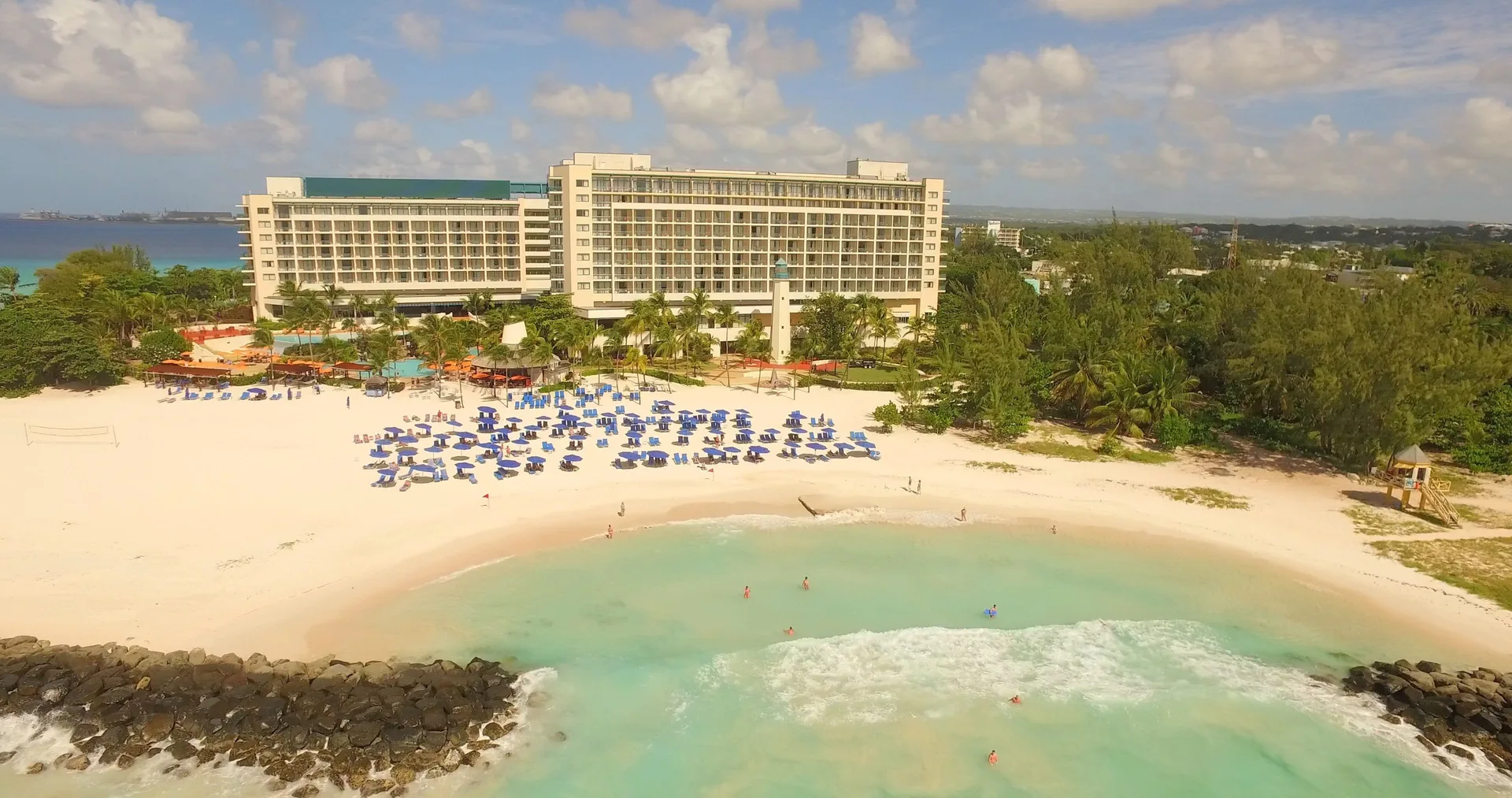 Aerial view of the beachfront, turquoise water, and resort buildings at Hilton Barbados Resort.