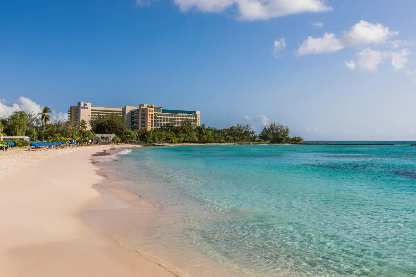 Sandy beach and clear turquoise water beside Hilton Barbados Resort.