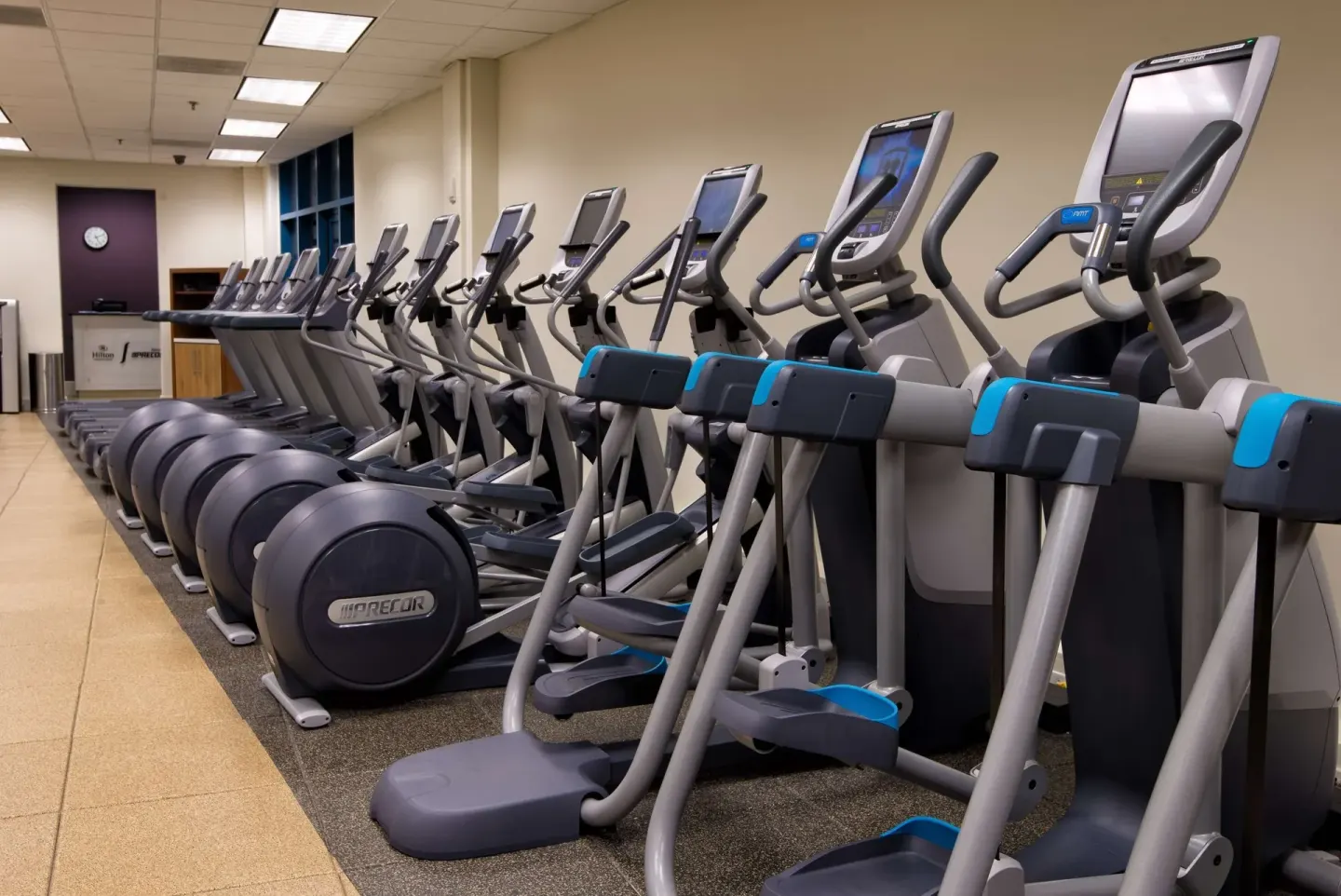 Row of cardio machines in the fitness center at Hilton Barbados Resort.