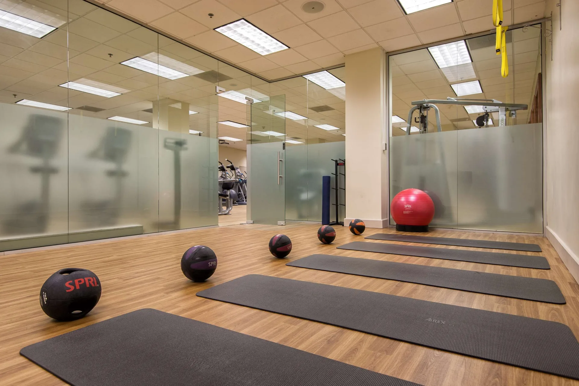 Exercise mats, medicine balls, and a stability ball in the fitness studio at Hilton Barbados Resort.