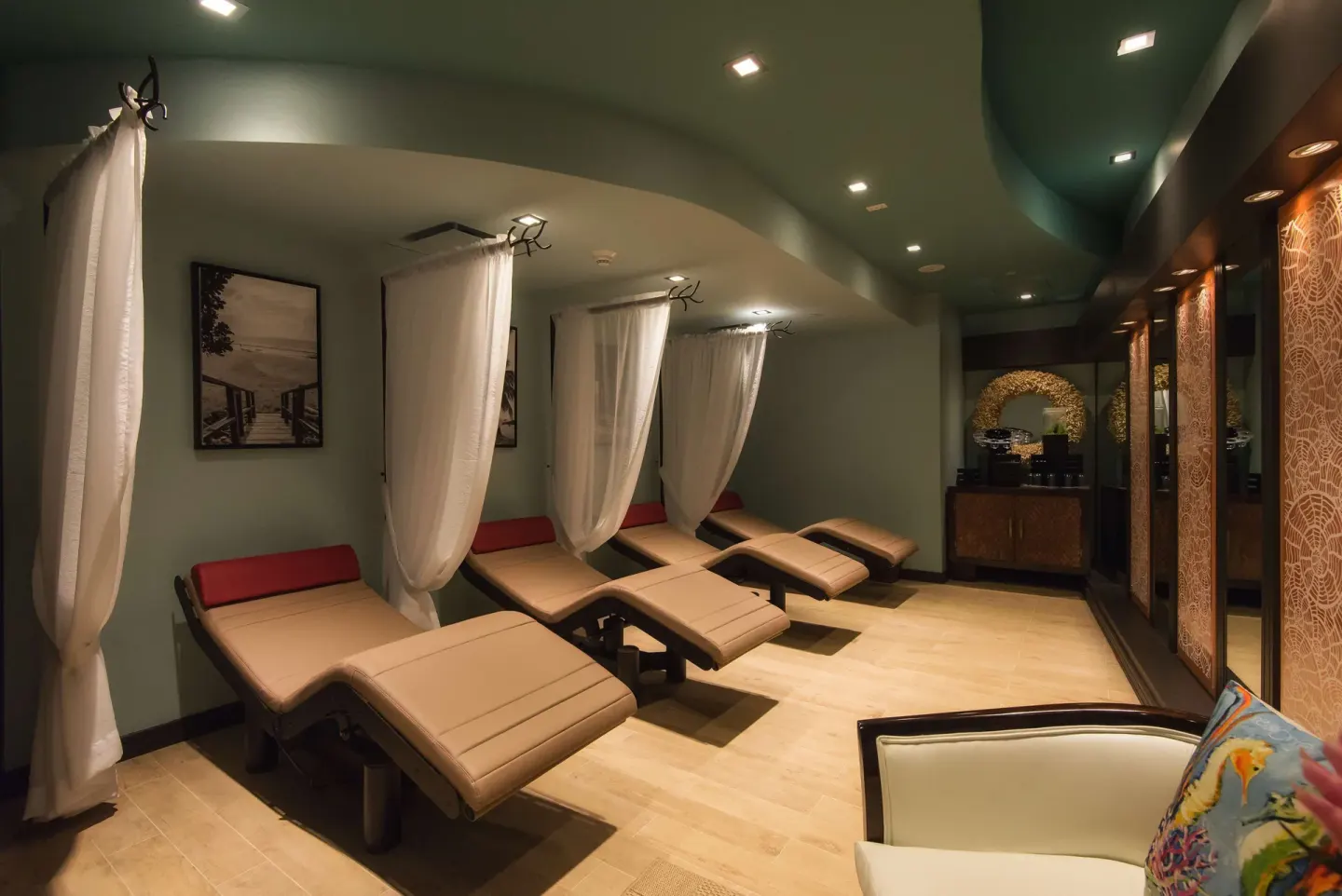 Spa relaxation room with curtained loungers at Hilton Barbados Resort.