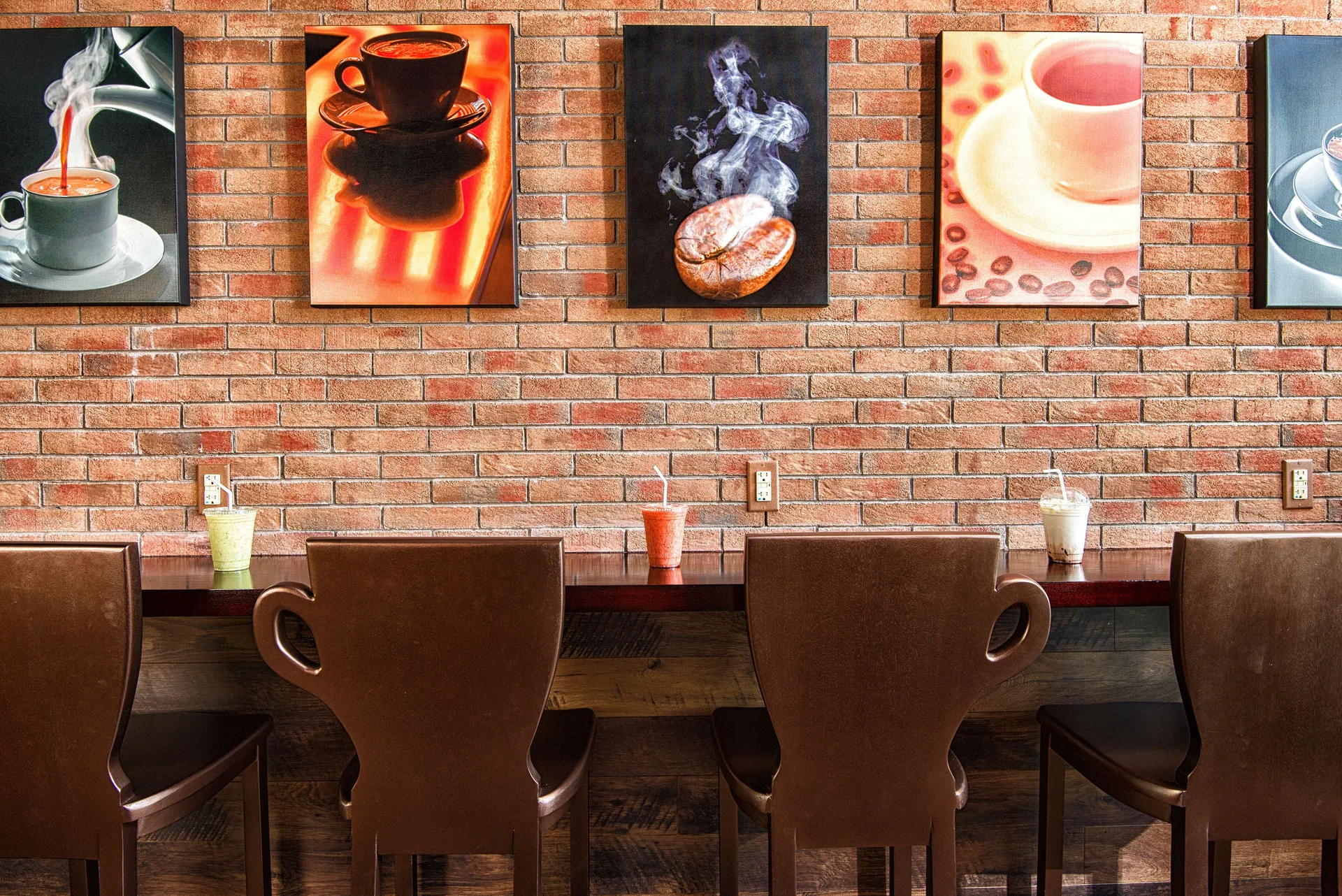 Coffee-themed counter seating with drinks on a brick wall at Hilton Barbados Resort.