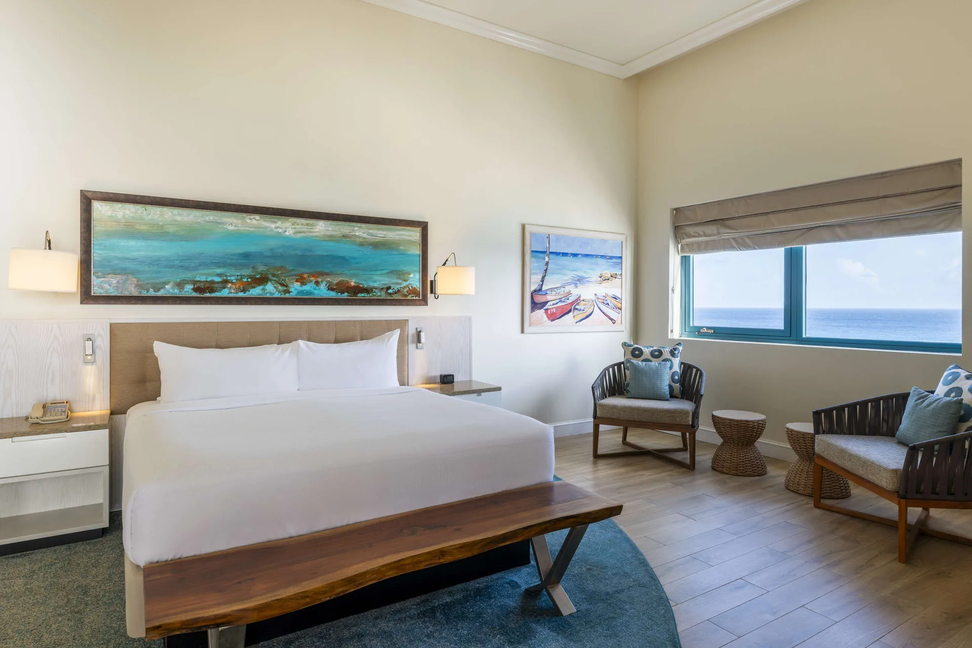Premium suite king bedroom with ocean window view at Hilton Barbados Resort.
